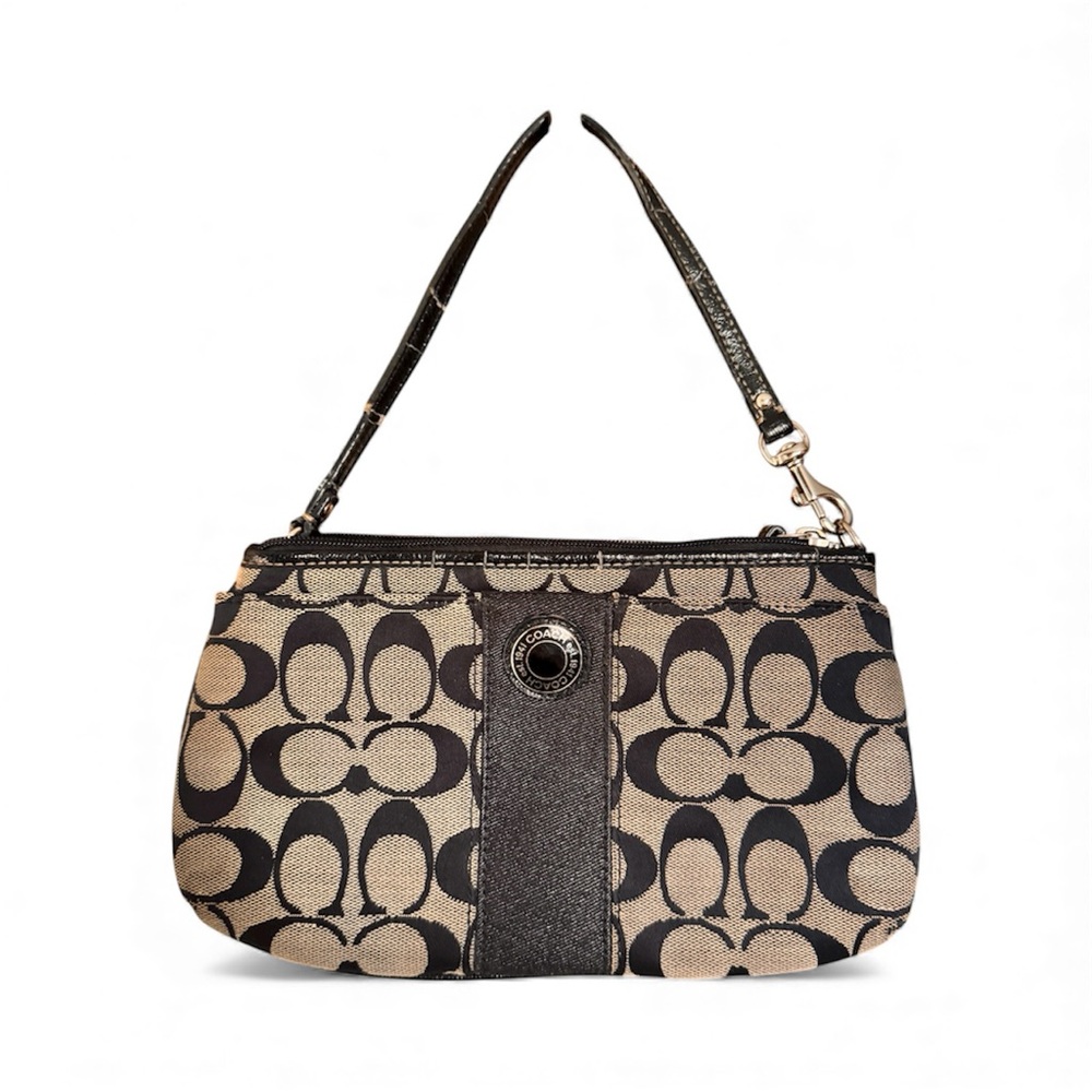 Coach wristlet in black signature canvas with a zip top and front pocket